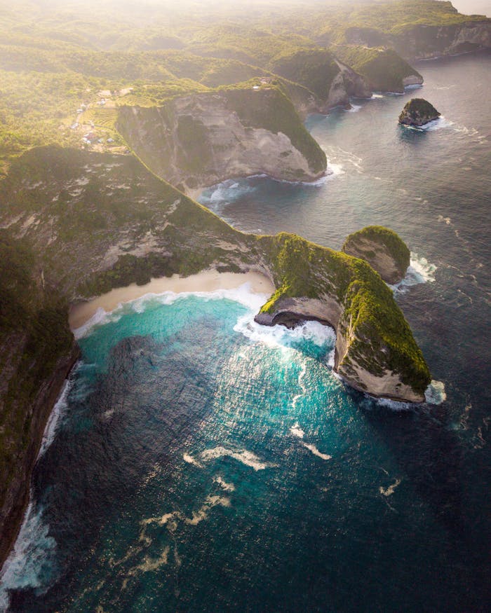 mobile-01 Stunning aerial view of Bali's coastline with turquoise waters and lush cliffs.